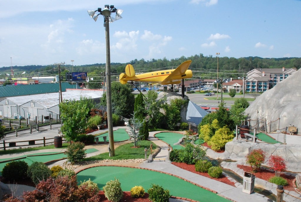 Mini golf course, one of many cheap kid-friendly things to do in Pigeon Forge, TN, with scenic landscaping.