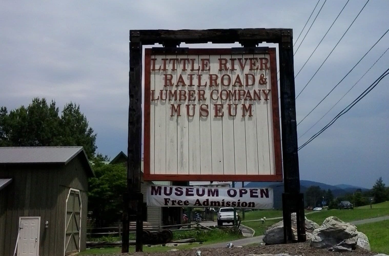 Rustic wooden sign for Little River Railroad & Lumber Company Museum with free admission.