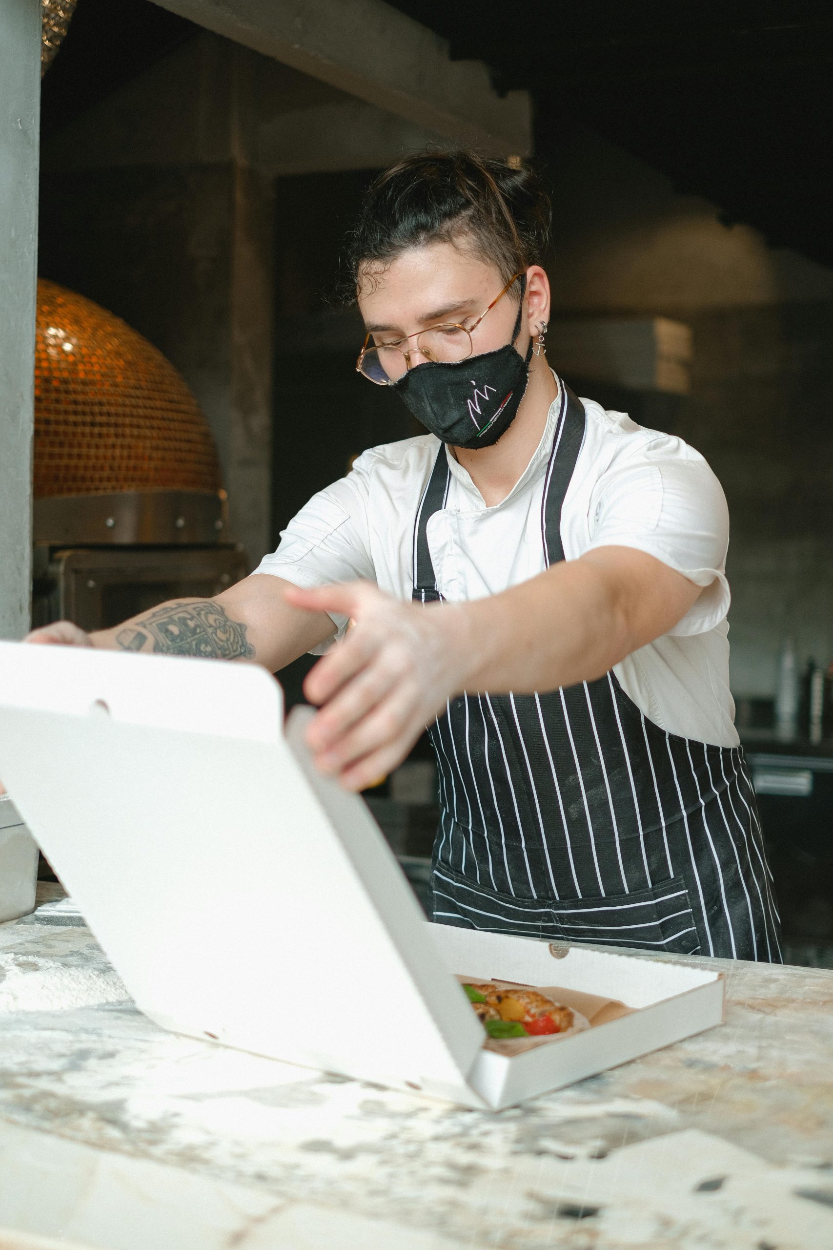 A chef boxing a pizza for delivery in Pigeon Forge