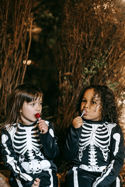 Kids enjoying candies, capturing festive halloween in Pigeon Forge vibes.
